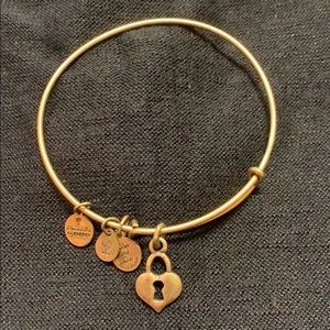 Goldtone Alex and Ani bracelet with locket charm